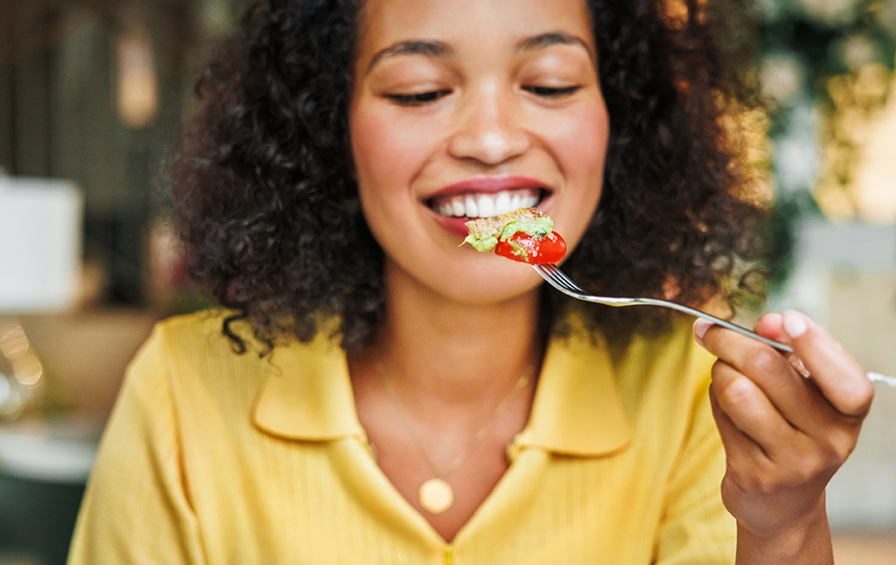 Person smiling at salad