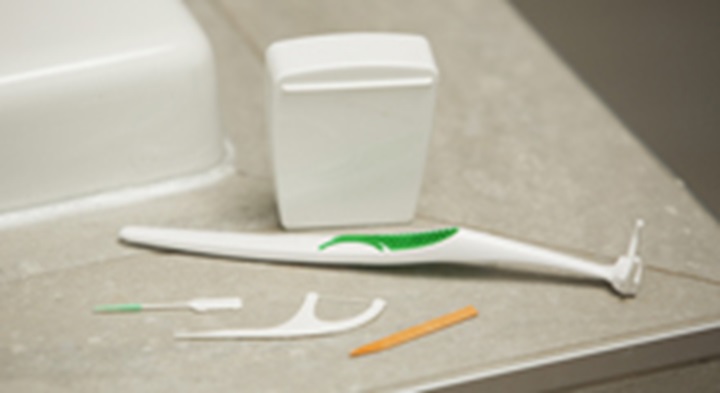 Woman flossing teeth.