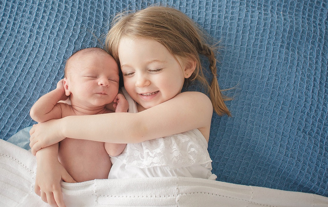 Child and infant hugging