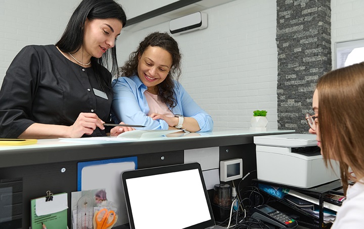 Individuals comparing answers on paperwork