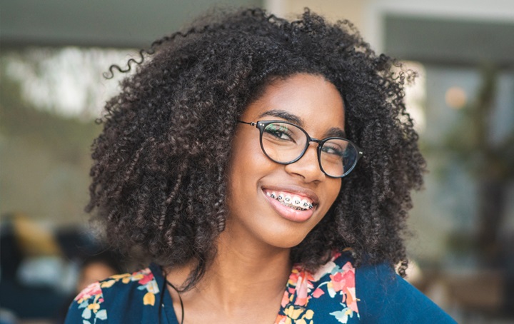 A woman smiling with braces.