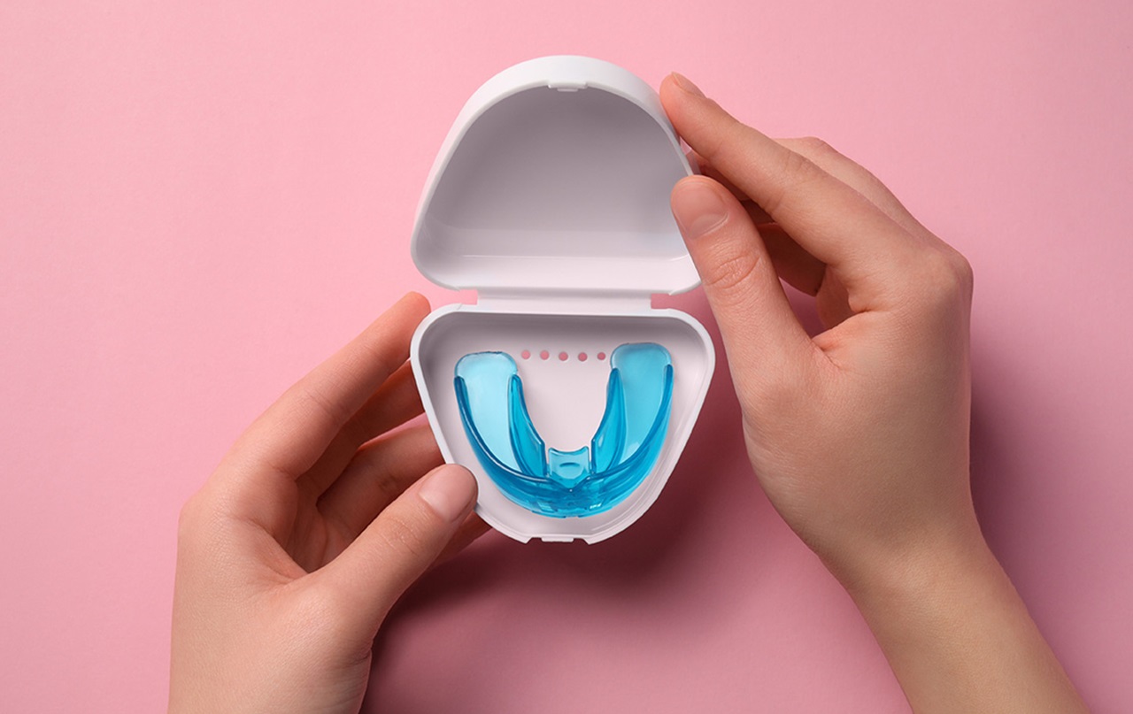 Someone holding open case with mouthguard