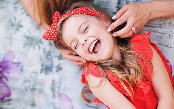 Girl in red smiling and laughing